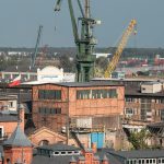 Historic shipyard and cranes in Gdańsk, showcasing industrial heritage.
